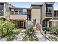 Charming townhouse featuring a well-maintained front yard, and a unique architectural design at 1111 N Bayshore Blvd # E10, Clearwater, FL 33759