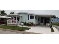 Charming single-story home with well-maintained lawn, carport, and covered porch at 123 S Dolphin Dr, Oldsmar, FL 34677