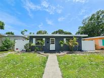 Charming single-story home with a well-maintained front yard and inviting walkway to the front door at 1416 55Th N Ave, St Petersburg, FL 33703