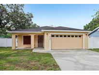 Charming single-story home featuring a spacious two-car garage and well-maintained lawn at 212 W Humphrey St, Tampa, FL 33604