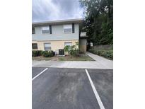 Two-story apartment building with light blue siding and beige accents, surrounded by green bushes and a concrete walkway at 226 Thorn Tree Pl # 226, Brandon, FL 33510