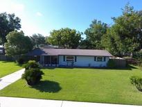 Charming one-story home with a well-maintained lawn and mature trees creating a welcoming curb appeal at 38320 14Th Ave, Zephyrhills, FL 33542