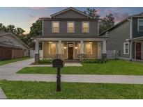 Charming two-story home featuring a welcoming front porch with stylish stone accents at 406 E Selma Ave, Tampa, FL 33603