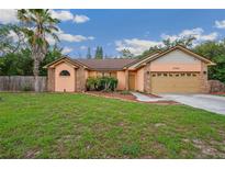 Charming single-story home boasts a well-manicured lawn and attached two-car garage at 4744 Burlington Rd, Land O Lakes, FL 34639