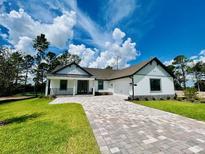 Beautiful single-story home with paver driveway and well-manicured lawn at 4773 Hickory Oak Dr, Brooksville, FL 34601