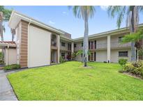 Charming condo complex with well-maintained lawn and beautiful palm trees at 19029 Us Highway 19 N # 3-1, Clearwater, FL 33764
