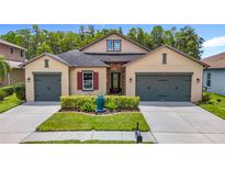 Inviting home with a well-kept lawn, dual garage, and charming architectural details at 1958 Marshberry Ct, Trinity, FL 34655
