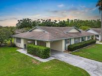 Charming single-story home featuring a well-maintained lawn, carport, and mature landscaping at 2006 Hadrian Ct, Sun City Center, FL 33573