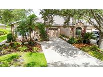 Charming single Gathering home featuring a well manicured lawn and attached garage at 5143 Lochmead Ter, Zephyrhills, FL 33541
