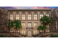 Beautiful historic building with many windows, palm trees, and elegant architectural details at 701 Mirror Lake N Dr # 103, St Petersburg, FL 33701