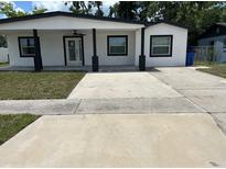 Charming single-story home with fresh exterior paint, large driveway, and a welcoming front entrance at 7021 Parliament Dr, Tampa, FL 33619