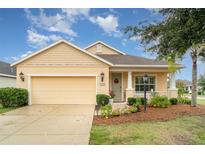Charming single-story home with a manicured lawn, attached garage, and inviting front porch at 11849 Forest Park Cir, Bradenton, FL 34211