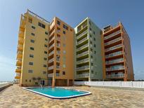 View of the lovely condos with a community pool and tile lounging area at 18610 Gulf Blvd # 208, Indian Shores, FL 33785