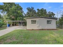 Charming single-story home with a cozy carport and well-maintained lawn at 2018 Windsor Way, Tampa, FL 33619