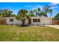 Charming single-story home with a well-manicured lawn, a palm tree, and a one car garage at 2066 62Nd Pl S 62Nd Pl, St Petersburg, FL 33712