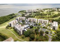 Stunning aerial view of the community with pool, parking, and views of the bay at 2900 Cove Cay Dr # 7C, Clearwater, FL 33760