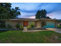 Charming single-story home with well-maintained lawn, colorful landscaping, and a welcoming front entrance at 3242 Brushwood Ct, Clearwater, FL 33761