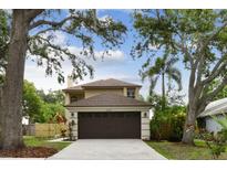 Charming two-story home features a two-car garage, manicured landscaping and mature trees at 3673 Fremantle Dr, Palm Harbor, FL 34684