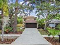 Charming two-story home with a well-manicured lawn, two-car garage and mature trees in a desirable community at 3673 Fremantle Dr, Palm Harbor, FL 34684