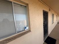Exterior view of a condo with a window and security gate entrance at 4137 Lake Bayshore Dr # C505, Bradenton, FL 34205