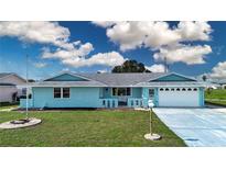 Charming single-story home with a well-manicured lawn and attached two-car garage at 624 La Jolla Ave, Sun City Center, FL 33573