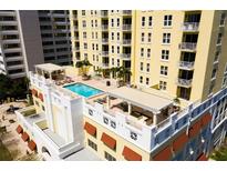 Stunning rooftop pool and lounge area with pergolas in a modern high-rise condo building at 628 Cleveland St # 711, Clearwater, FL 33755