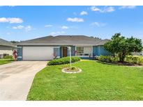 Charming single-story home with a lush green lawn, manicured landscaping, and a welcoming two-car garage at 6324 35Th Avenue E Cir, Palmetto, FL 34221