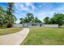 Charming single-story home with a well-maintained lawn and white picket fence at 6601 13Th N St, St Petersburg, FL 33702
