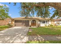 Charming home featuring stone accents, a well-maintained lawn, and a double door entryway at 9309 120Th St, Seminole, FL 33772
