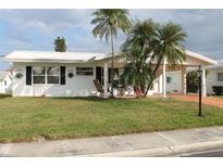 Charming single-story home with palm trees and a well-maintained front yard at 9705 45Th N Way, Pinellas Park, FL 33782
