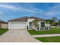 Charming single-story home with a well-manicured lawn, a two-car garage, and lovely curb appeal at 15403 Wicked Strong St, Sun City Center, FL 33573