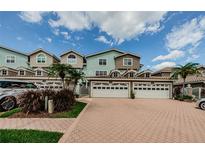 Charming townhomes showcase light paint, arched windows and terra cotta driveways, perfect for low-maintenance living at 1710 Lago Vista Blvd, Palm Harbor, FL 34685