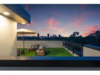 Relaxing rooftop patio offers comfortable seating and picturesque views of the city skyline at sunset at 2120 4Th S St, St Petersburg, FL 33705