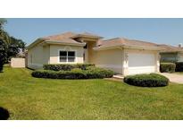 Charming single-story home featuring a well-maintained lawn and manicured bushes at 2784 Alexander Dr, Clearwater, FL 33763