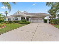 Inviting exterior with a well-manicured lawn, mature landscaping, and a covered three-car carport at 4306 Barracuda Dr, Bradenton, FL 34208