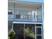 Two-story condo showcasing a screened-in lanai on the ground floor and a second-story balcony at 5860 43Rd N Ter # 1518, Kenneth City, FL 33709