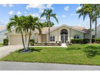 Charming single-story home featuring lush landscaping and a welcoming front entrance at 6009 Cedarwood Ln, Bradenton, FL 34203