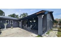 Charming covered front porch with decorative accents and rocking chairs at 7515 Brookhaven Ct, Tampa, FL 33634