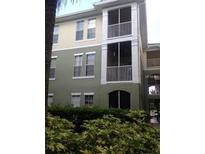 Three-story condo with two screened balconies and manicured shrubbery at 9320 Crescent Loop Cir # 304, Tampa, FL 33619