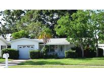 Charming single-story home with a well-maintained lawn and mature landscaping at 10871 86Th Ave, Seminole, FL 33772