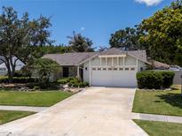 Charming single-story home featuring a well-manicured lawn and an attached two-car garage at 12506 Twisted Oak Dr, Tampa, FL 33624