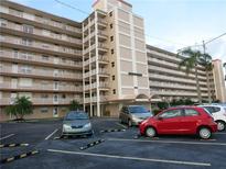 Multi-story condo building showcasing its exterior with balconies and parking area at 1847 Shore Drive S # 415, South Pasadena, FL 33707