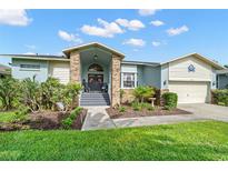 Charming single-story home with a welcoming entrance, beautiful landscaping, and a two-car garage at 338 7Th N Ave, Tierra Verde, FL 33715