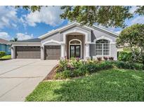 Charming one story home with a three car garage and beautiful landscaping at 5141 Riva Ridge Dr, Wesley Chapel, FL 33544