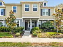 Charming townhome with a well-maintained lawn and beautiful landscaping adding curb appeal at 5170 Sea Mist Ln, Wesley Chapel, FL 33545