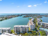 Stunning aerial view of a waterfront community with beautiful coastal scenery and luxurious condo buildings at 7932 Sailboat Key S Blvd # 406, South Pasadena, FL 33707