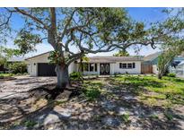 Inviting single-story home with a well-maintained front yard and a brick-paved driveway at 11490 48Th N Ave, St Petersburg, FL 33708