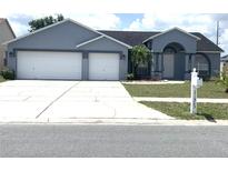 Charming one-story home with a well-manicured lawn, a two-car garage, and a welcoming front entrance at 11513 Andy Dr, Riverview, FL 33569