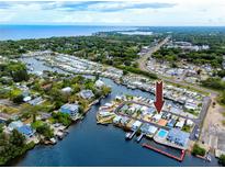 Enjoy this aerial view of waterfront community with docks, boats, and gulf access at 2011 Ketch Cir, Palm Harbor, FL 34683