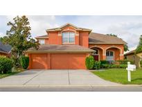 Charming two-story home with attached three car garage and well-maintained landscaping at 2038 Oswego Dr, Holiday, FL 34691